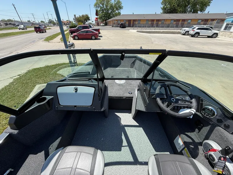 Slide: The Image of 2025 Lund 1650 Rebel XL Sport boat interior with steering wheel and seating. - 9