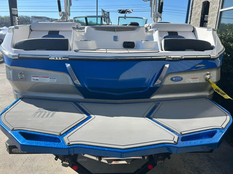 Slide: The Image of 2020 MasterCraft X24 boat, blue and gray, rear view with swim platform. - 6