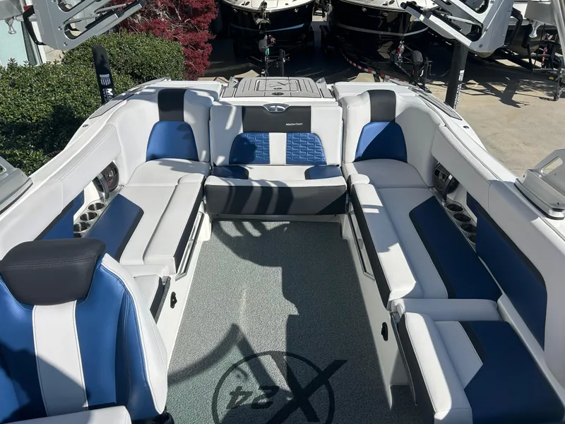 Slide: The Image of 2020 MasterCraft X24 boat interior with blue and white seating, showcasing luxury design. - 7