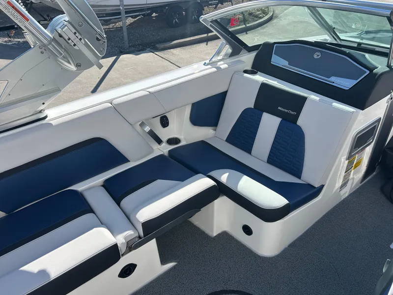 Slide: The Image of 2020 MasterCraft X24 boat interior with blue and white seating. - 9