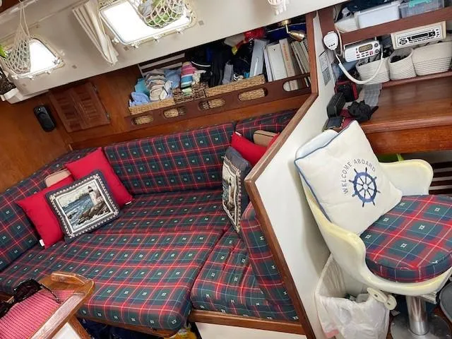 Slide: The Image of Cozy interior of 1980 Hunter 36 sailboat with plaid seating and nautical decor. - 12