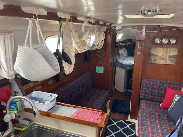 Slide: The Image of Interior of a 1980 Hunter 36 sailboat with plaid seating and nautical decor. - 17