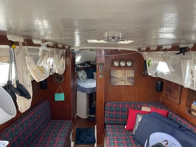 Slide: The Image of Interior of a 1980 Hunter 36 sailboat with plaid seating and cozy decor. - 20