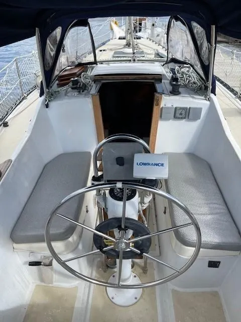 Slide: The Image of Cockpit of 1980 Hunter 36 sailboat with steering wheel and navigation equipment. - 7