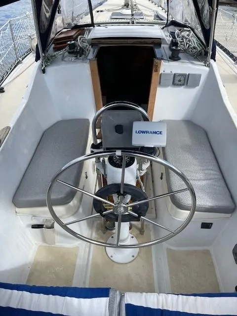 Slide: The Image of Cockpit of 1980 Hunter 36 sailboat with steering wheel and navigation equipment. - 9