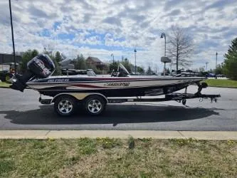 Slide: The Image of 2003 Stratos 201 Pro XL boat on trailer, parked outdoors under a cloudy sky. - 1