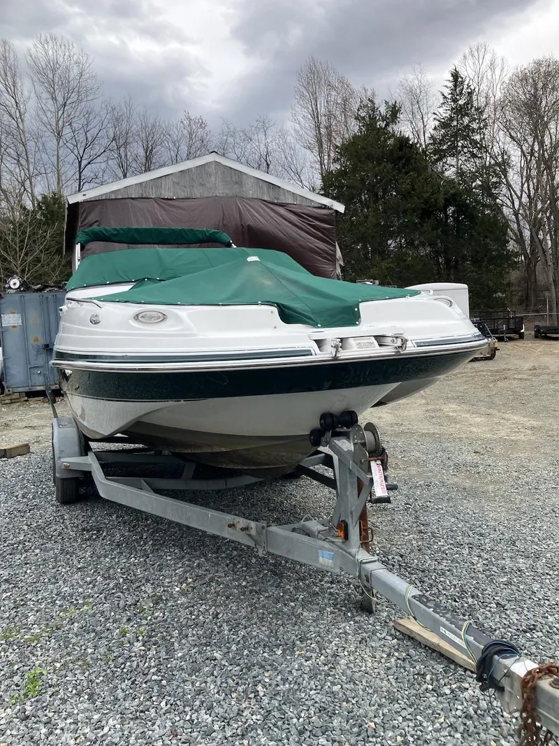 Slide: The Image of 2002 Four Winns 214 Funship boat on trailer, covered, outdoors. - 3