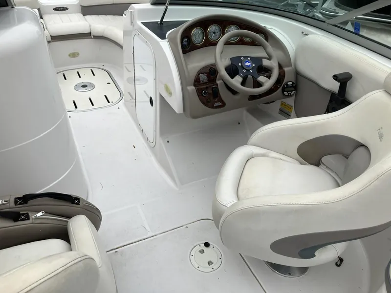 Slide: The Image of 2002 Four Winns 214 Funship boat interior with white seating and steering console. - 7
