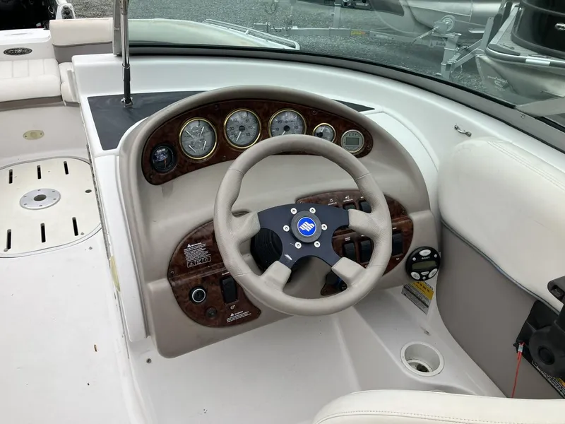 Slide: The Image of 2002 Four Winns 214 Funship boat dashboard with steering wheel and gauges. - 8