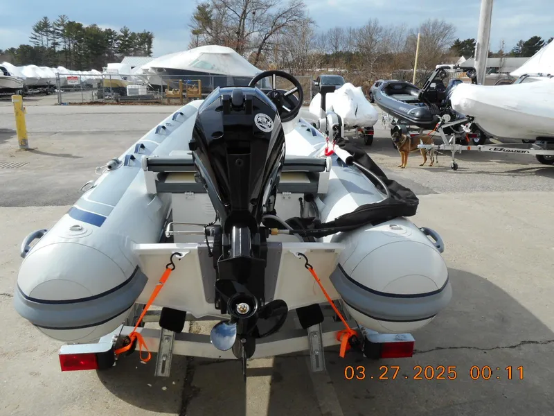 Slide: The Image of 2025 Highfield Classic 310 inflatable boat on trailer, rear view, outdoor setting. - 2