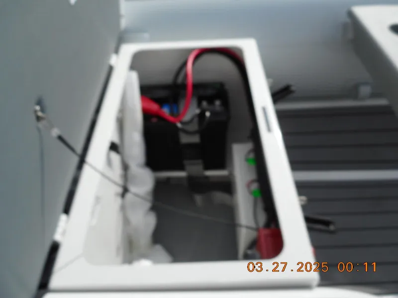 Slide: The Image of 2025 Highfield Classic 310 boat battery compartment with wiring and connections. - 3