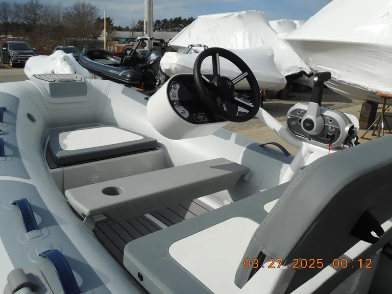 Slide: The Image of 2025 Highfield Classic 310 boat interior with steering wheel and seating. - 7