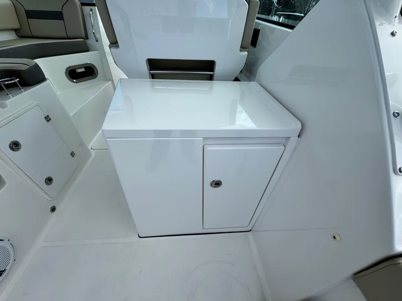 Slide: The Image of 2019 Pursuit DC 325 Dual Console interior with white storage cabinet. - 13