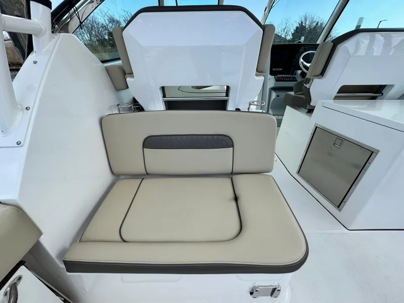 Slide: The Image of 2019 Pursuit DC 325 Dual Console interior seating with beige cushions and modern design. - 15
