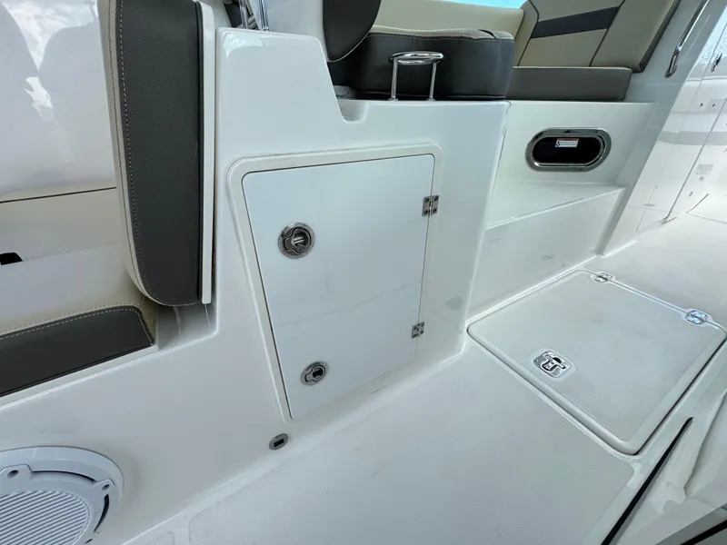 Slide: The Image of 2019 Pursuit DC 325 Dual Console interior with storage compartments and seating. - 19