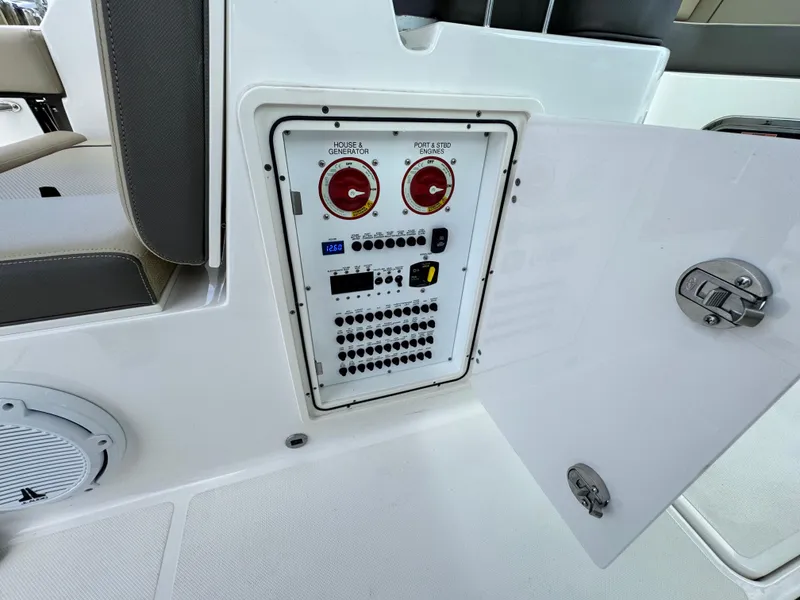 Slide: The Image of Electrical panel on a 2019 Pursuit DC 325 Dual Console boat, open compartment view. - 20