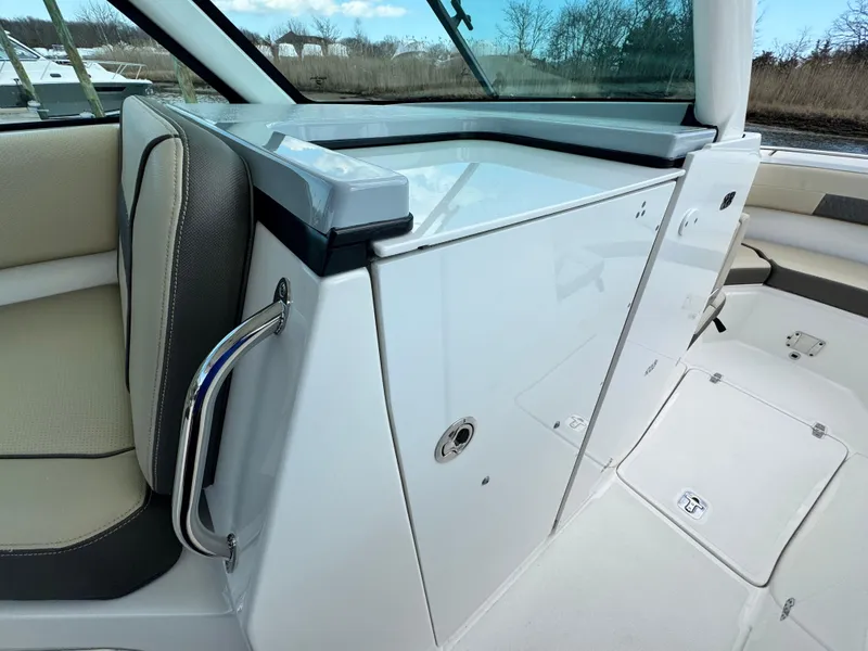 Slide: The Image of 2019 Pursuit DC 325 Dual Console interior with seating and storage compartments. - 26