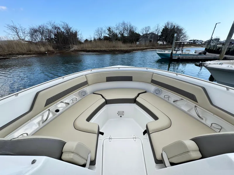 Slide: The Image of 2019 Pursuit DC 325 Dual Console boat with spacious seating, docked by a serene waterway. - 29