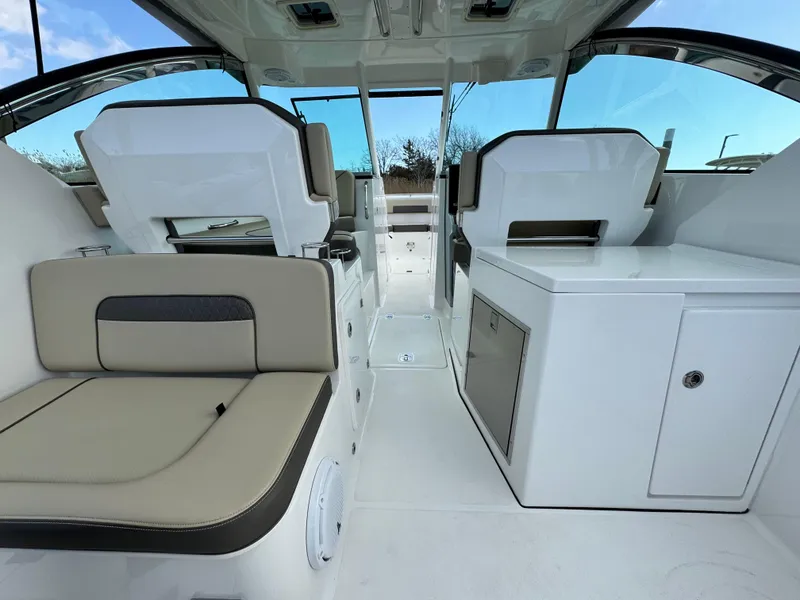 Slide: The Image of 2019 Pursuit DC 325 Dual Console interior with seating and storage, showcasing modern design. - 7