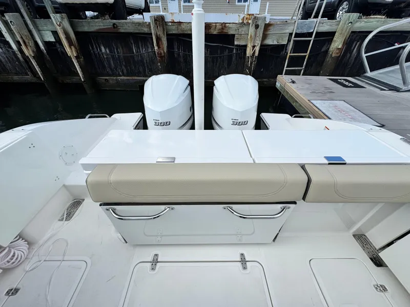 Slide: The Image of 2019 Pursuit DC 325 Dual Console boat with twin engines at dock. - 8