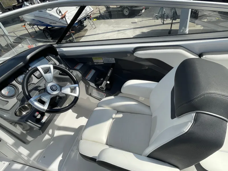 Slide: The Image of 2015 Yamaha AR240 High Output boat interior with steering wheel and captain's seat. - 11