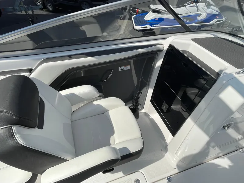 Slide: The Image of 2015 Yamaha AR240 High Output boat interior with white seating and storage compartment. - 13
