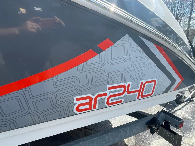 Slide: The Image of 2015 Yamaha AR240 High Output boat with sleek design and bold graphics. - 6