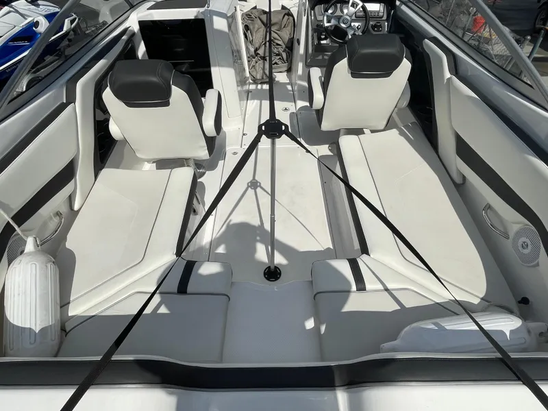 Slide: The Image of 2015 Yamaha Boats AR240 High Output interior with white seating and steering console. - 8