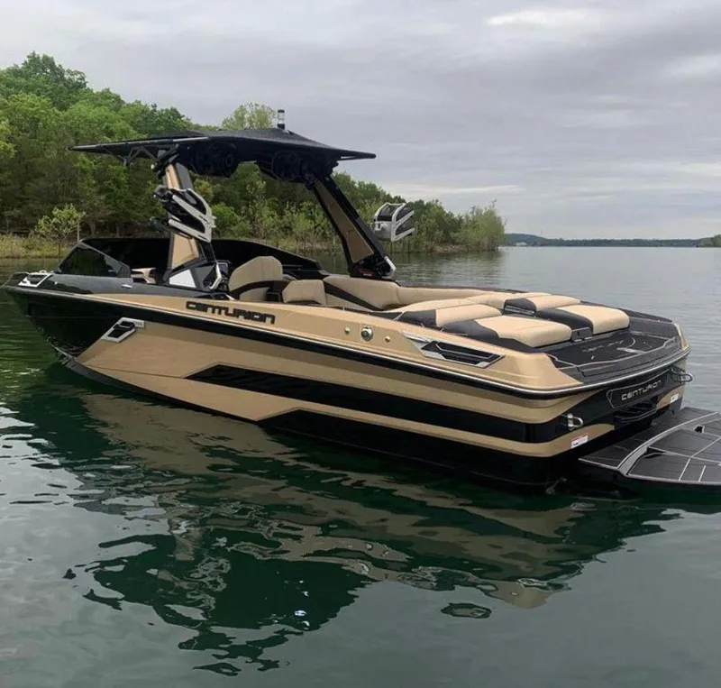 Slide: The Image of 2021 Centurion Ri265 boat on a calm lake with lush green shoreline. - 15