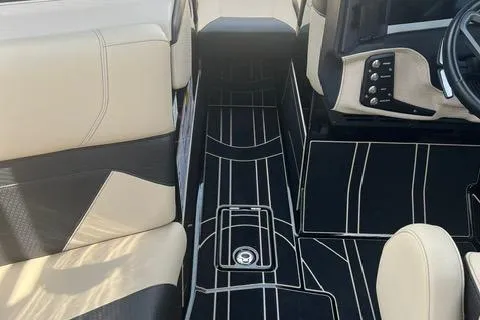 Slide: The Image of Interior of 2021 Centurion Ri265 boat with beige and black seating and sleek dashboard. - 8