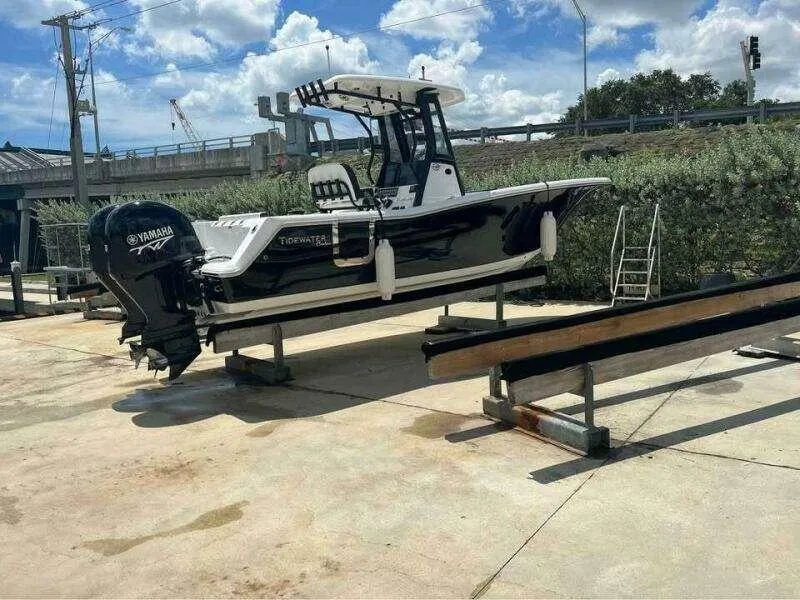 Slide: The Image of 2023 Tidewater 256 CC Adventure boat on trailer, Yamaha engine, outdoor setting. - 12
