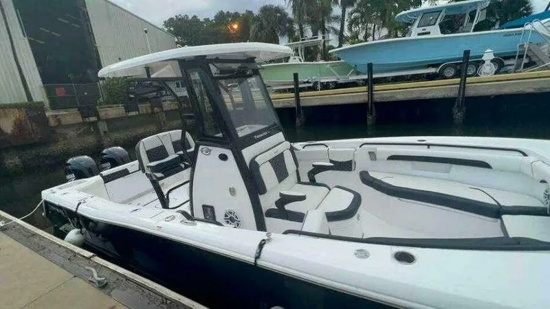 Slide: The Image of 2023 Tidewater 256 CC Adventure boat docked, featuring sleek design and spacious seating. - 5