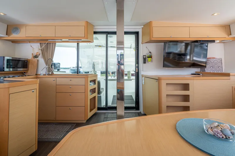 Slide: The Image of Interior of 2017 Lagoon 42 catamaran with modern kitchen and dining area. - 25