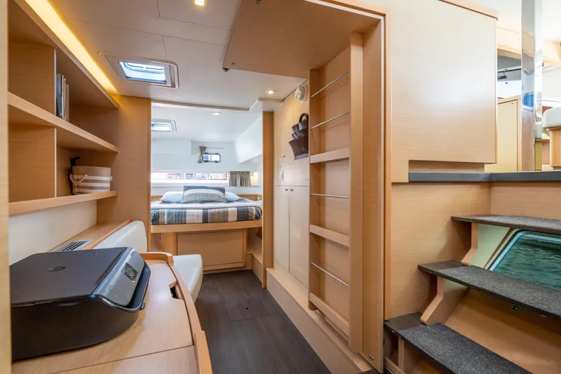 Slide: The Image of Interior of 2017 Lagoon 42 catamaran featuring cozy bedroom and modern workspace. - 30