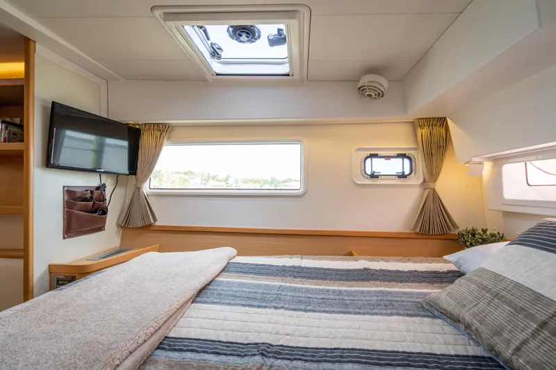 Slide: The Image of Luxurious cabin interior of 2017 Lagoon 42 catamaran with cozy bedding and natural light. - 35