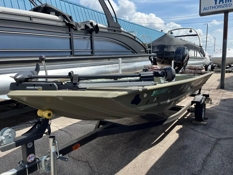 Slide: The Image of 2022 Tracker Grizzly 1648 Jon boat on trailer, parked outdoors under blue sky. - 4