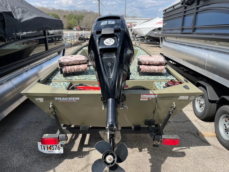 Slide: The Image of 2022 Tracker Grizzly 1648 Jon boat with outboard motor, parked in a lot. - 8