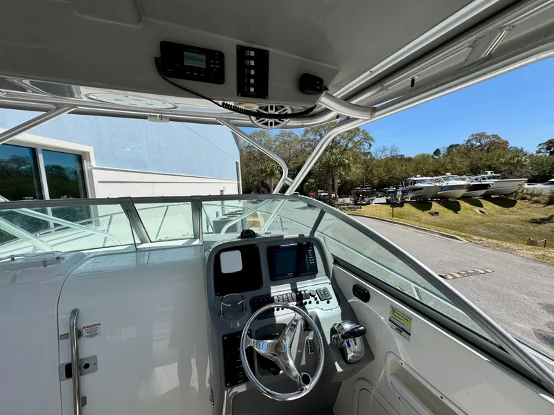 Slide: The Image of 2015 Robalo R245 Walkaround boat cockpit with steering wheel and control panel. - 10
