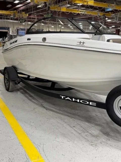 Slide: The Image of 2024 Tahoe 185 S boat on trailer in indoor facility. - 1