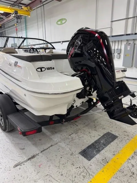 Slide: The Image of 2024 Tahoe 185 S boat with powerful outboard motor in a showroom. - 4