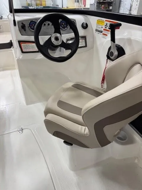 Slide: The Image of 2024 Tahoe 185 S boat interior with steering wheel and captain's chair. - 7
