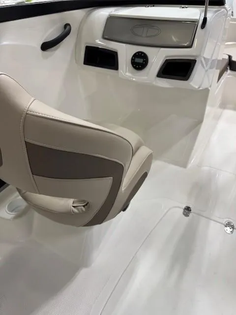 Slide: The Image of 2024 Tahoe 185 S boat interior with beige seating and modern dashboard design. - 8