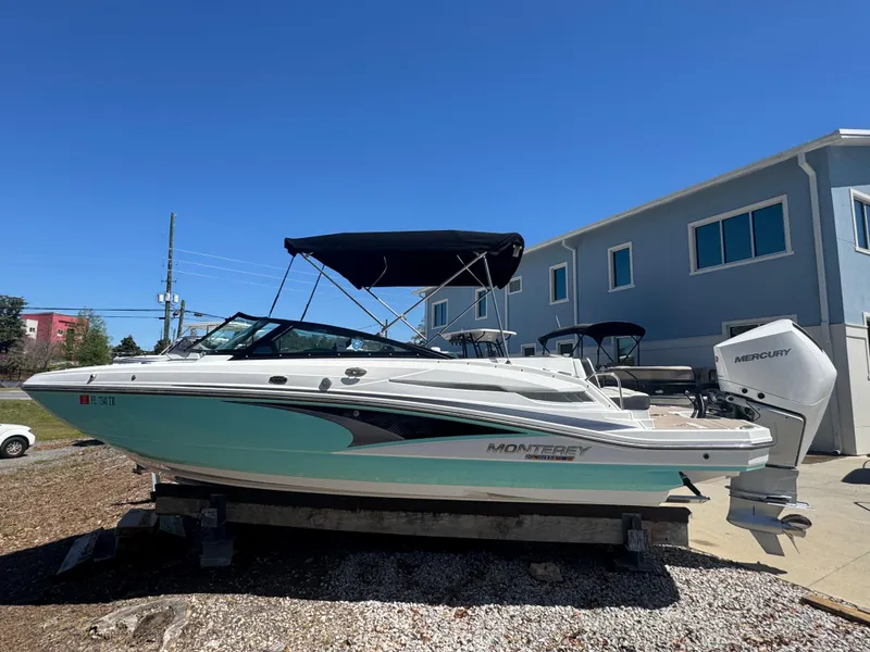 The Image of 2023 Monterey M-45 boat with canopy, docked outdoors under clear blue sky. - 1