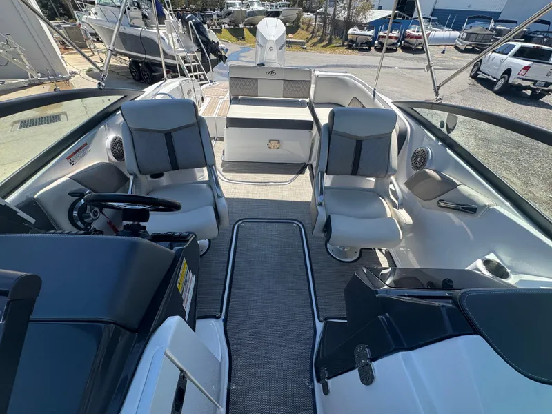 Slide: The Image of 2023 Monterey M-45 boat interior with seating and steering wheel, docked outdoors. - 4