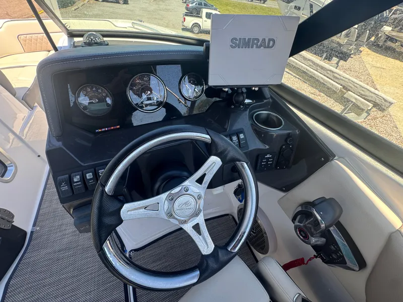 Slide: The Image of 2023 Monterey M-45 boat dashboard with steering wheel, Simrad display, and control panel. - 6
