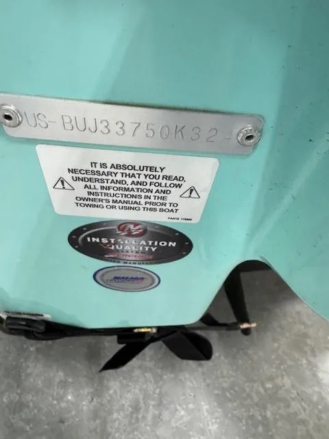 Slide: The Image of 2024 Tahoe 2150 CC boat hull with safety and installation labels. - 11