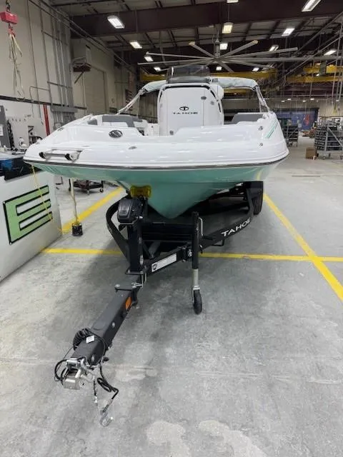 Slide: The Image of 2024 Tahoe 2150 CC boat on trailer in a warehouse setting. - 13