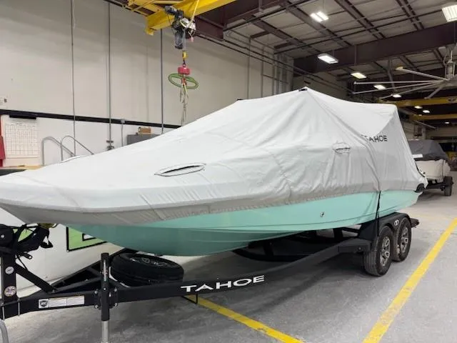 Slide: The Image of 2024 Tahoe 2150 CC boat covered on trailer in indoor storage facility. - 9