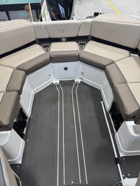 Slide: The Image of 2024 Tahoe 210 S Limited boat interior with cushioned seating and sleek flooring. - 10