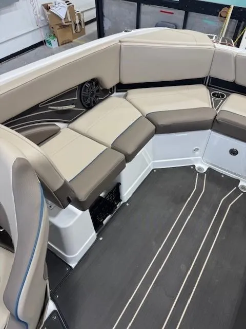 Slide: The Image of 2024 Tahoe 210 S Limited boat interior with beige seating and modern design. - 11